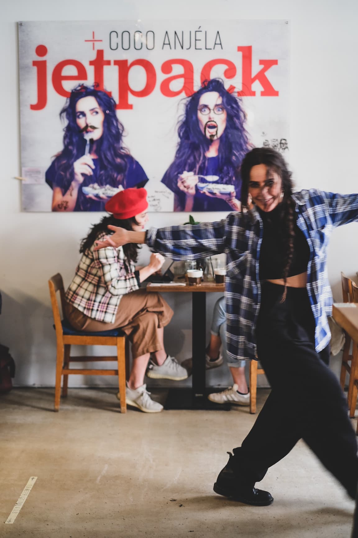Guest dancing in front of the Coco Anjela Jetpack artwork at a Factory Girl event