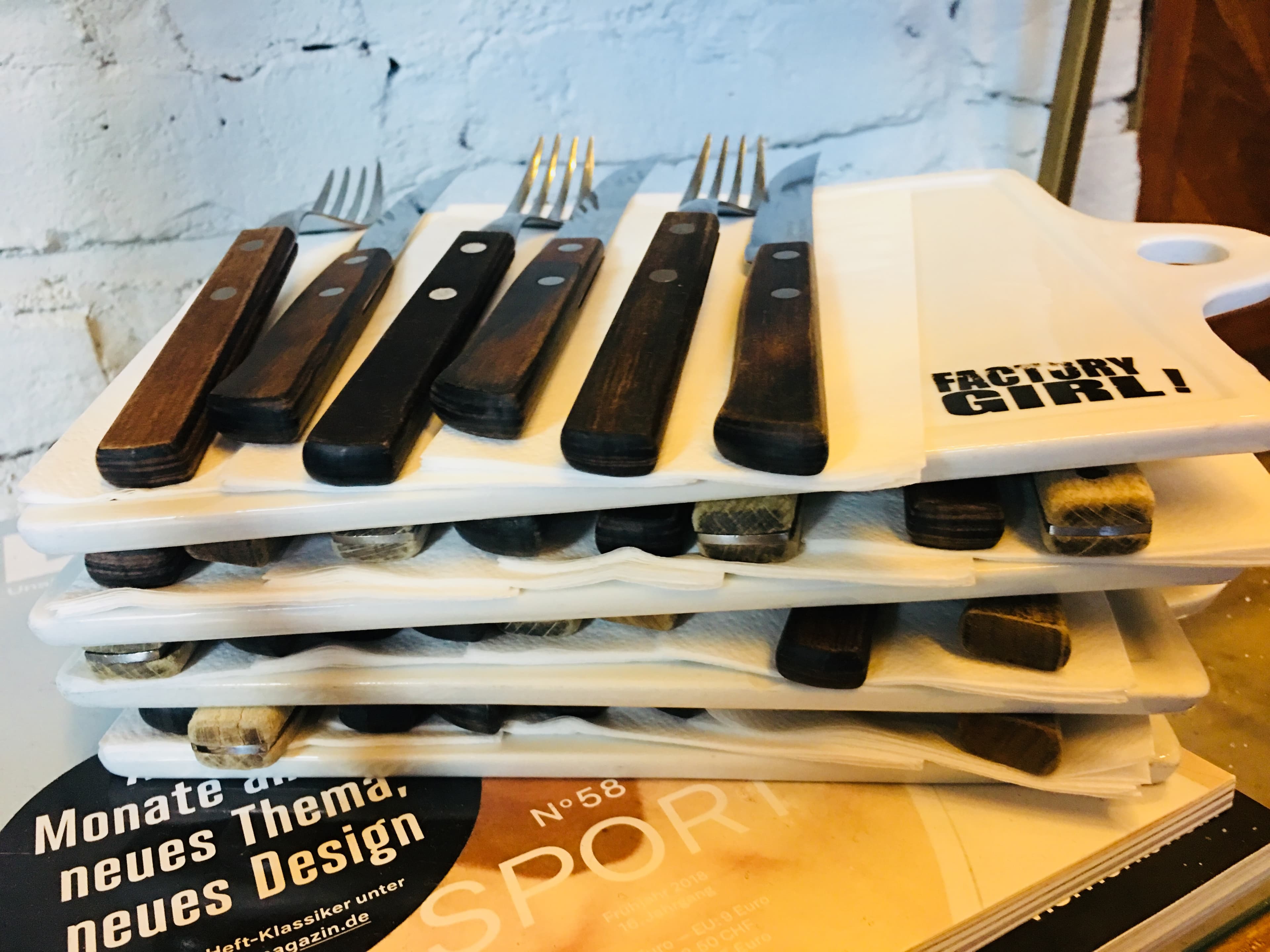Factory Girl Friedrichstraße — stacked branded boards with cutlery set for a private event