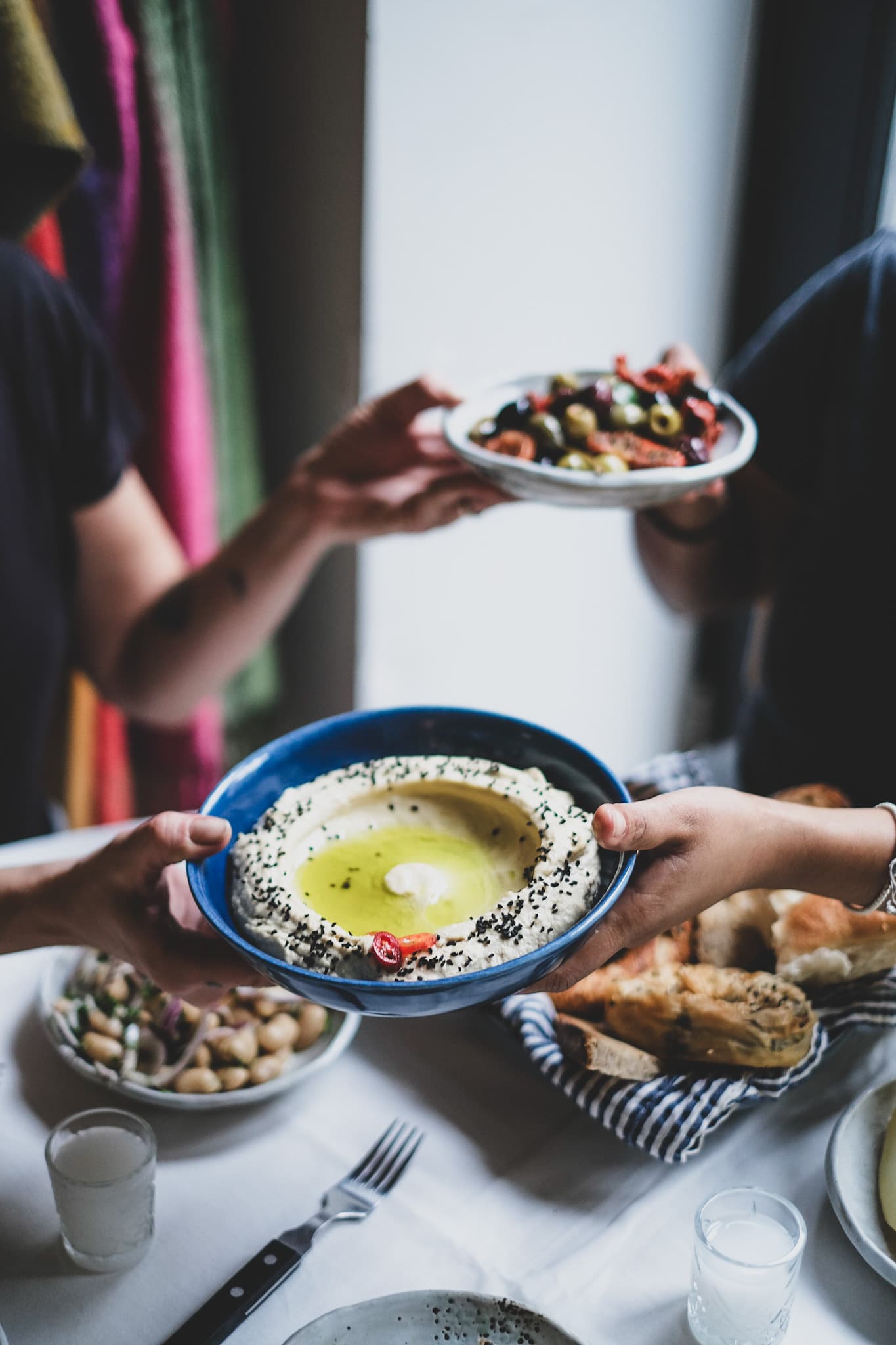 Shared dishes being passed around a communal Factory Girl table