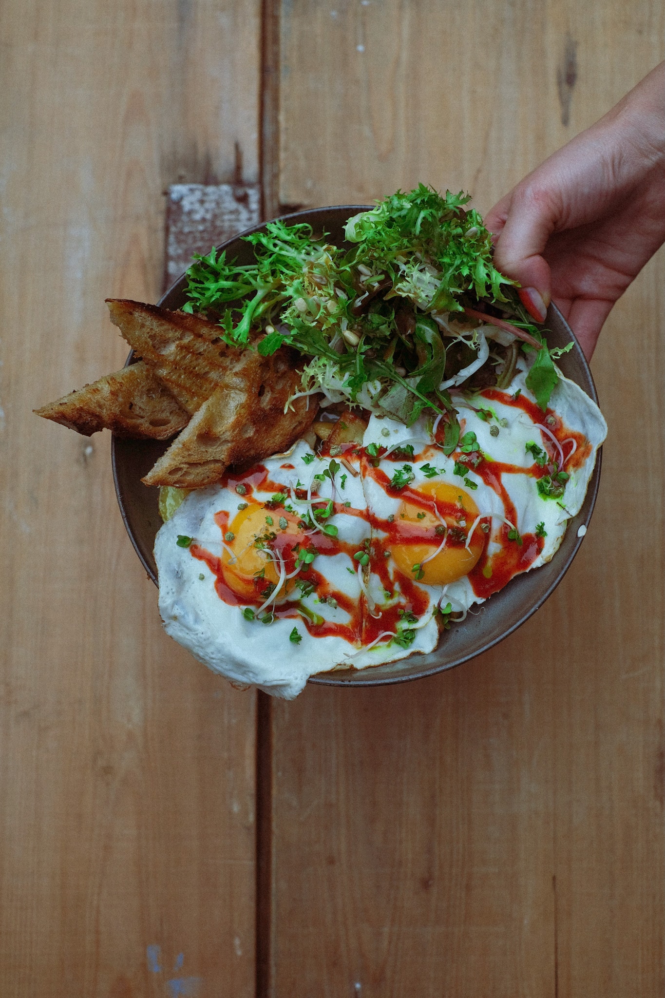 Factory Girl brunch plate held over a wooden table